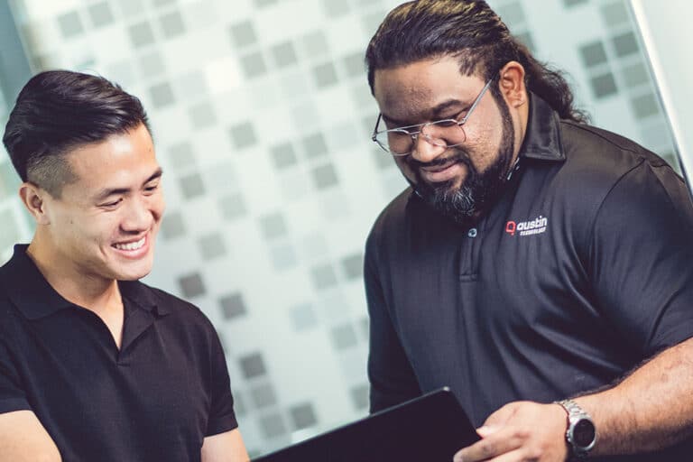 Two Austin Technology engineers going through an IT review on a tablet