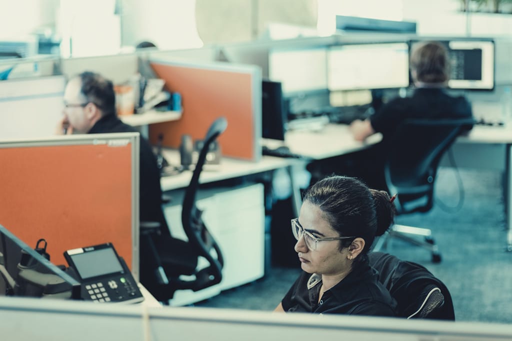 An Austin Technology engineer at a desk in the Subiaco office