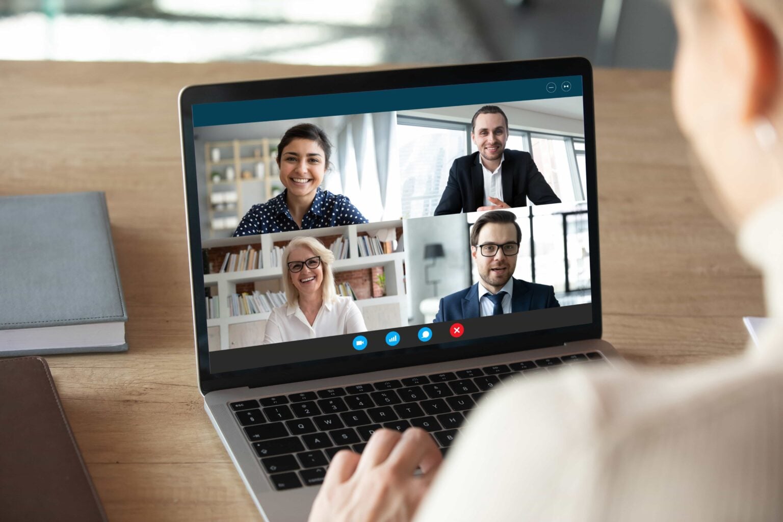 A video call with three colleagues on a laptop
