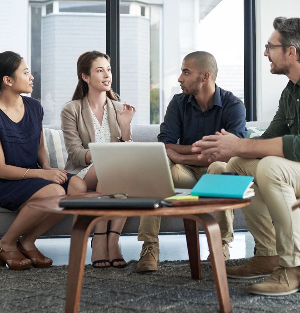 A team talking through findings around a laptop