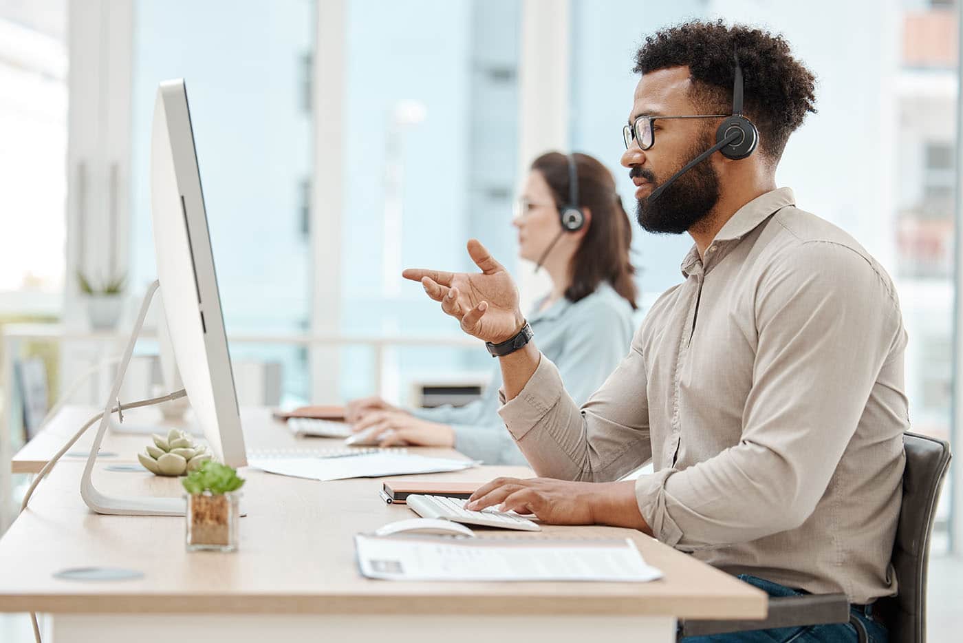 A service desk engineer on a call at his desk