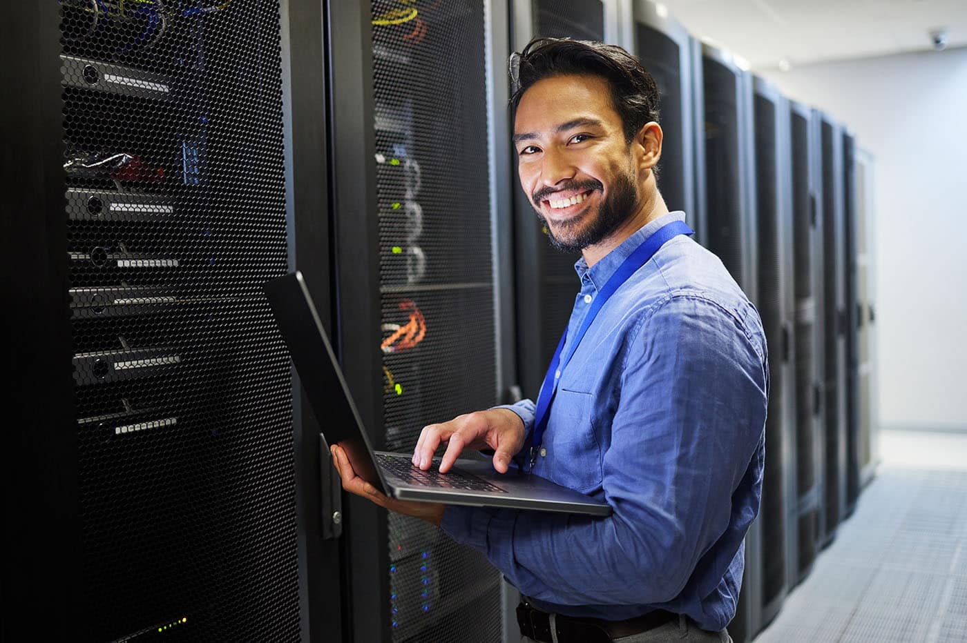 Engineer with a laptop in a server room