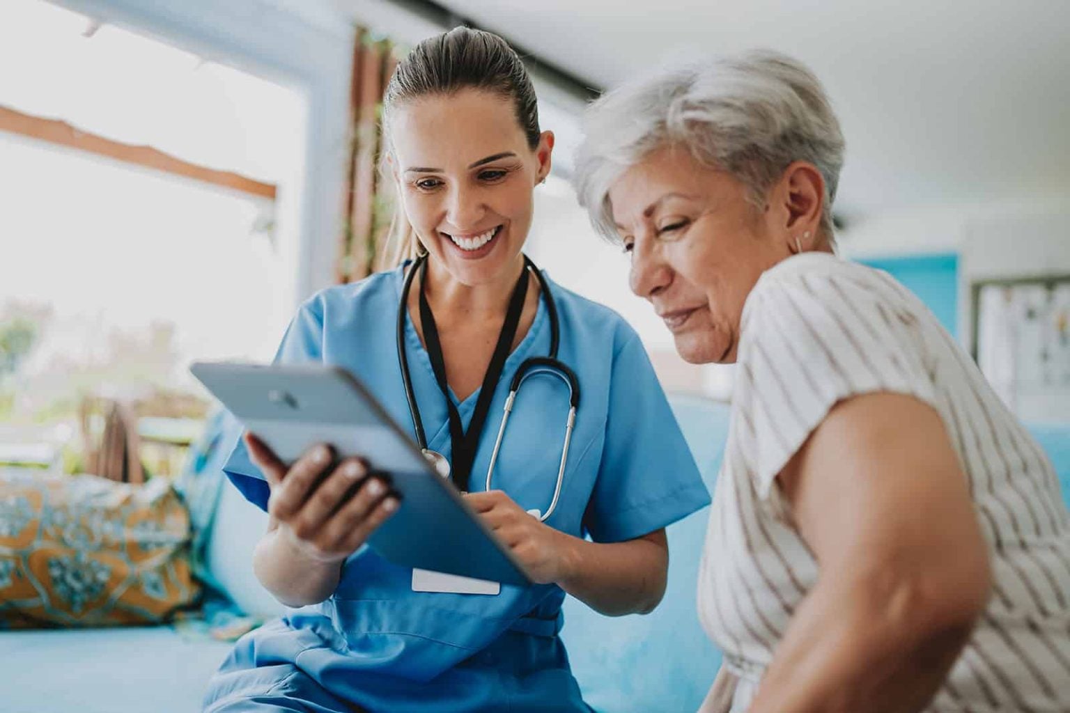 A nurse showing a patient information on a tablet