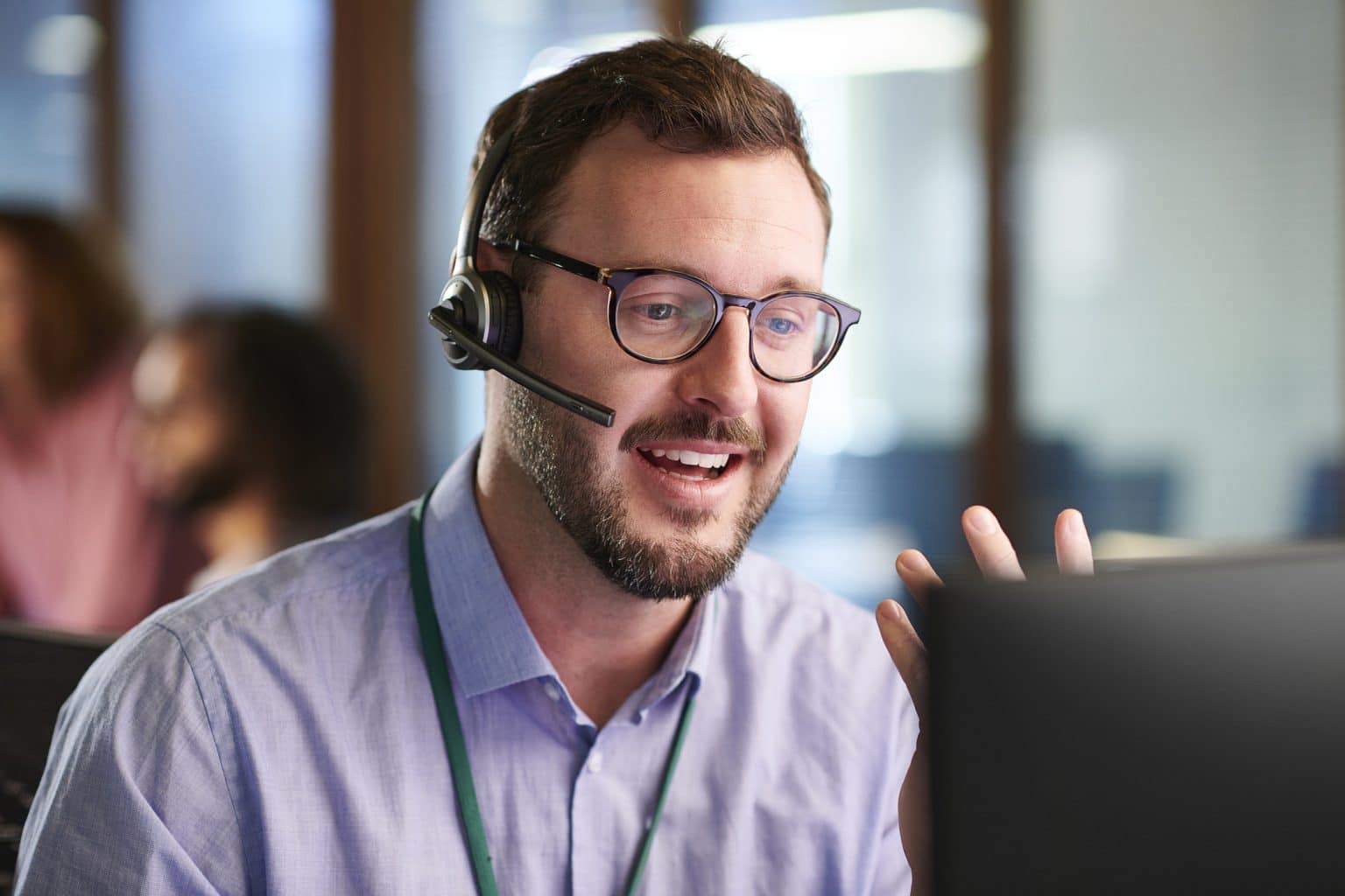 A service engineer smiling while he helps a caller