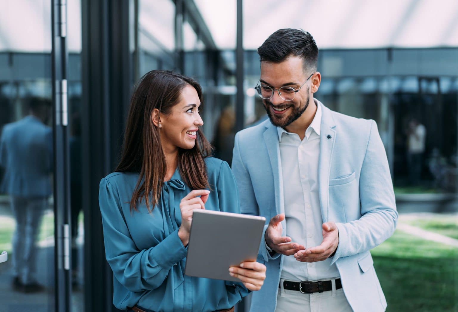 Two colleagues discussing a release over a tablet