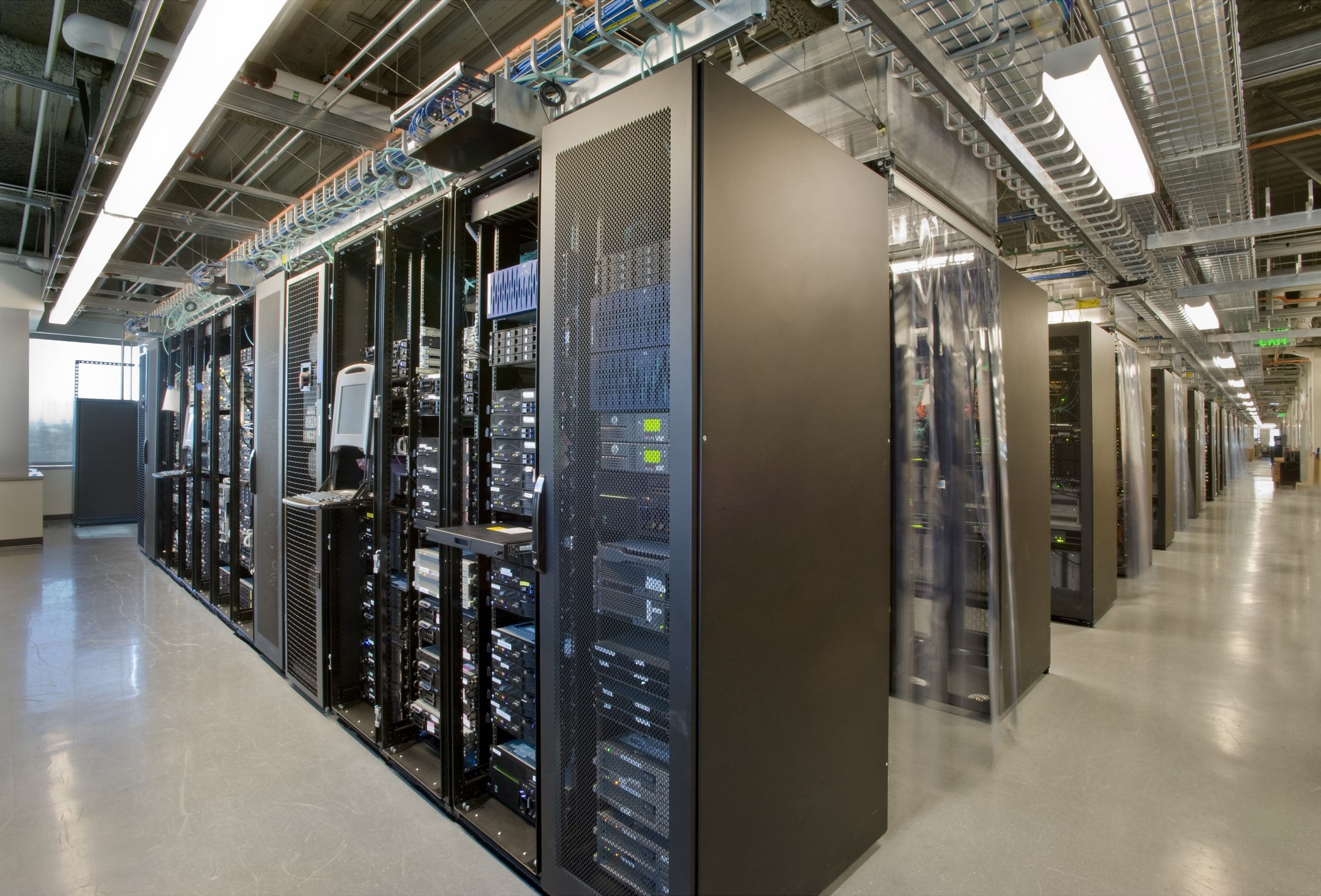 Long data centre aisle of server racks