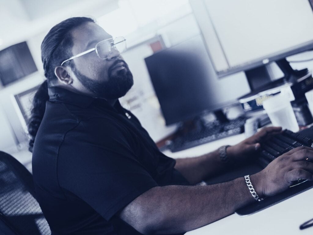 An Austin Technology engineer working through alerts at his desk