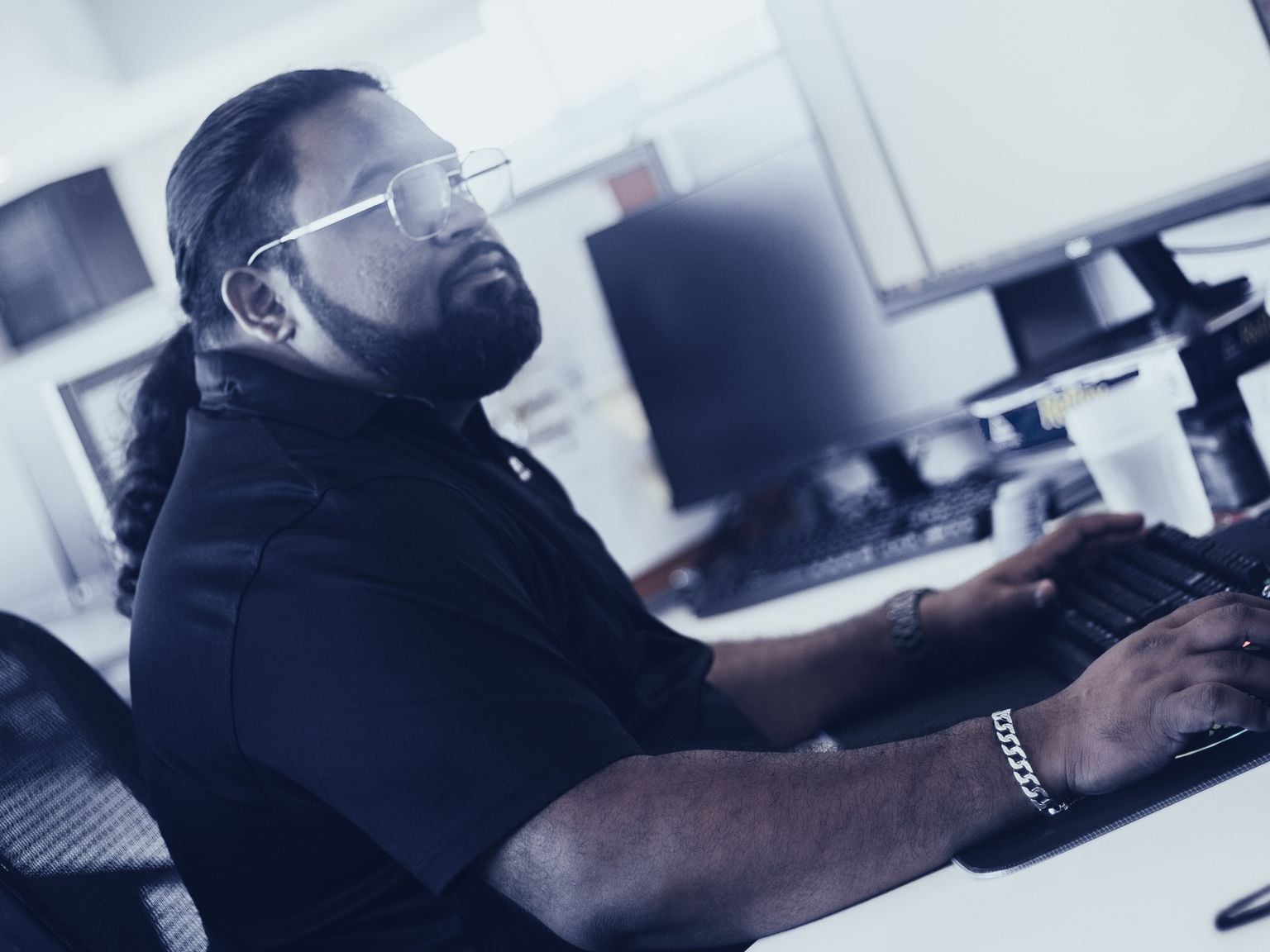 An Austin Technology engineer working through alerts at his desk