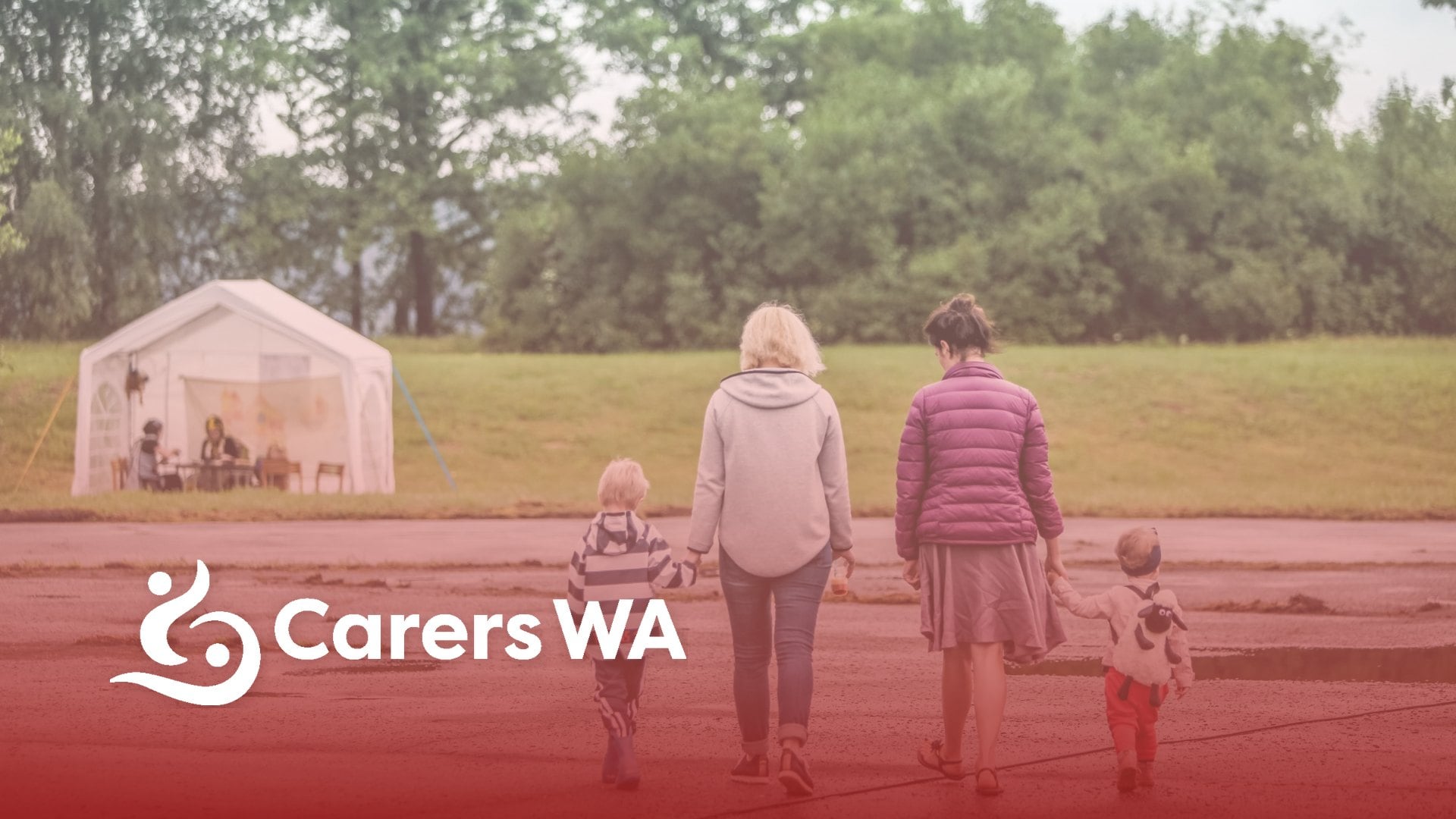 Carers WA logo over a family walking together through a park