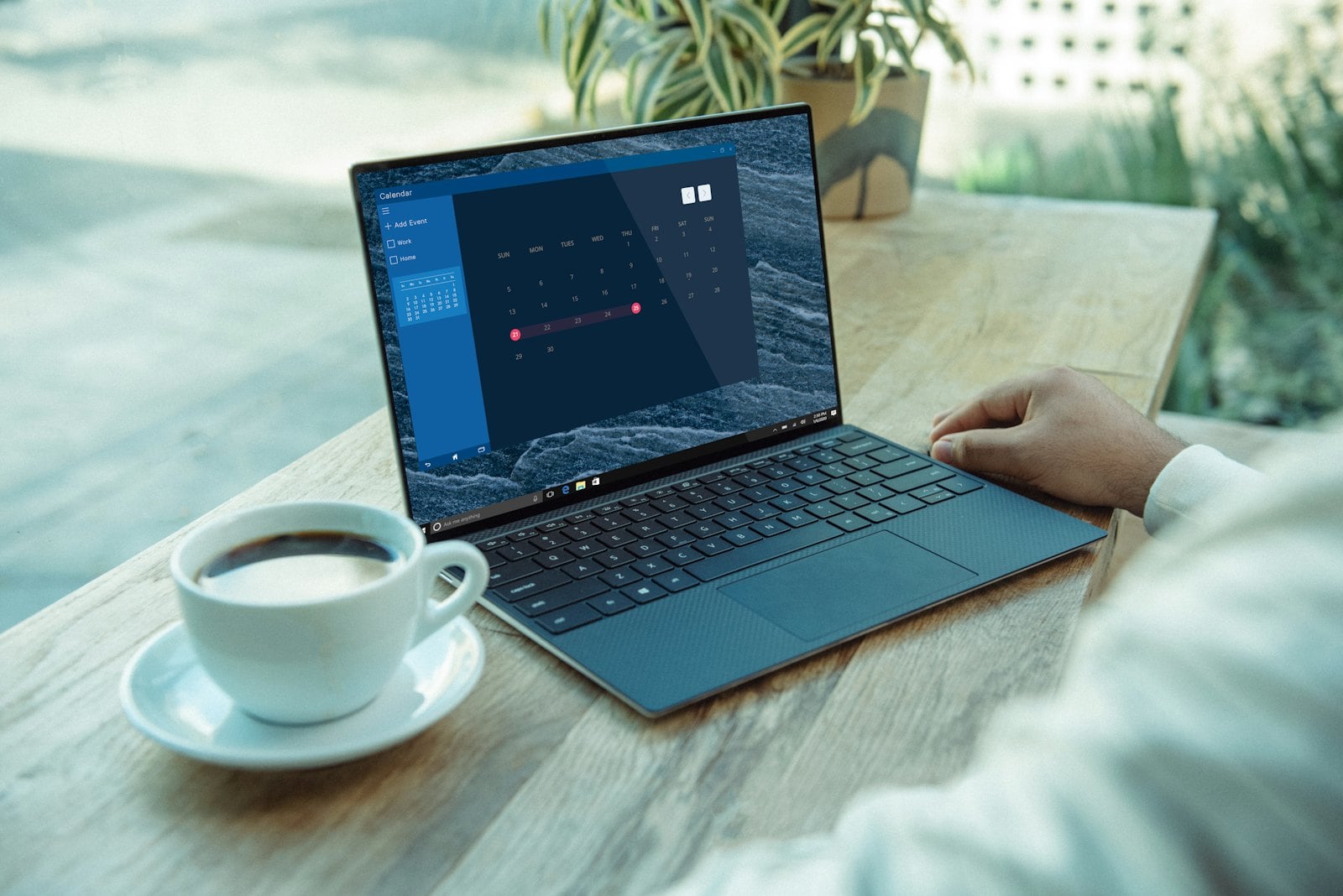 Laptop and a cup of coffee on a wooden table
