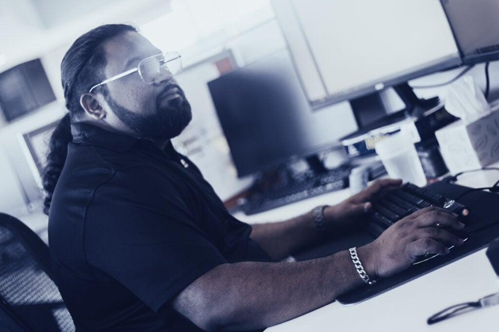 An Austin Technology engineer working through a ticket at his desk