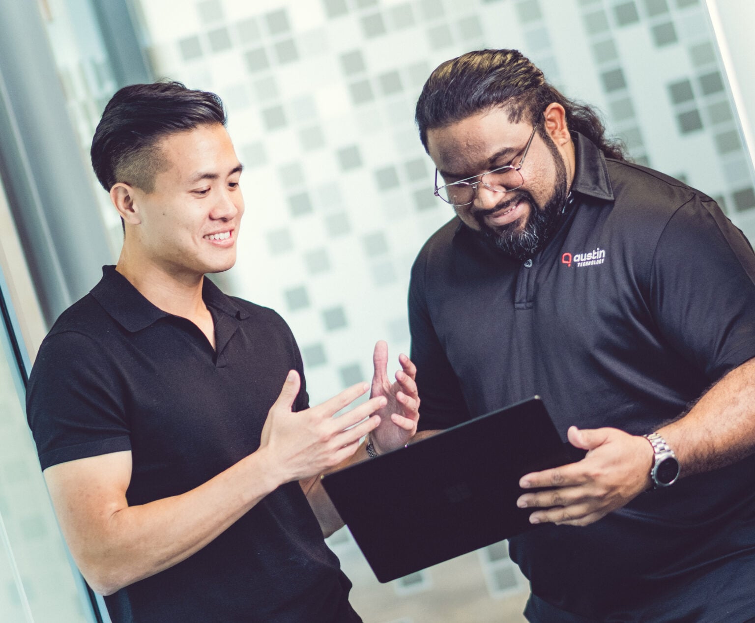 Two Austin Technology engineers talking through a plan