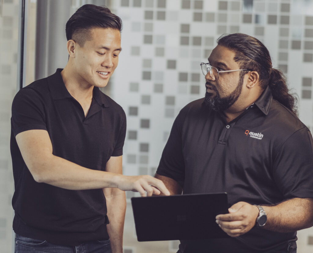 Two Austin Technology engineers talking through a plan on a tablet