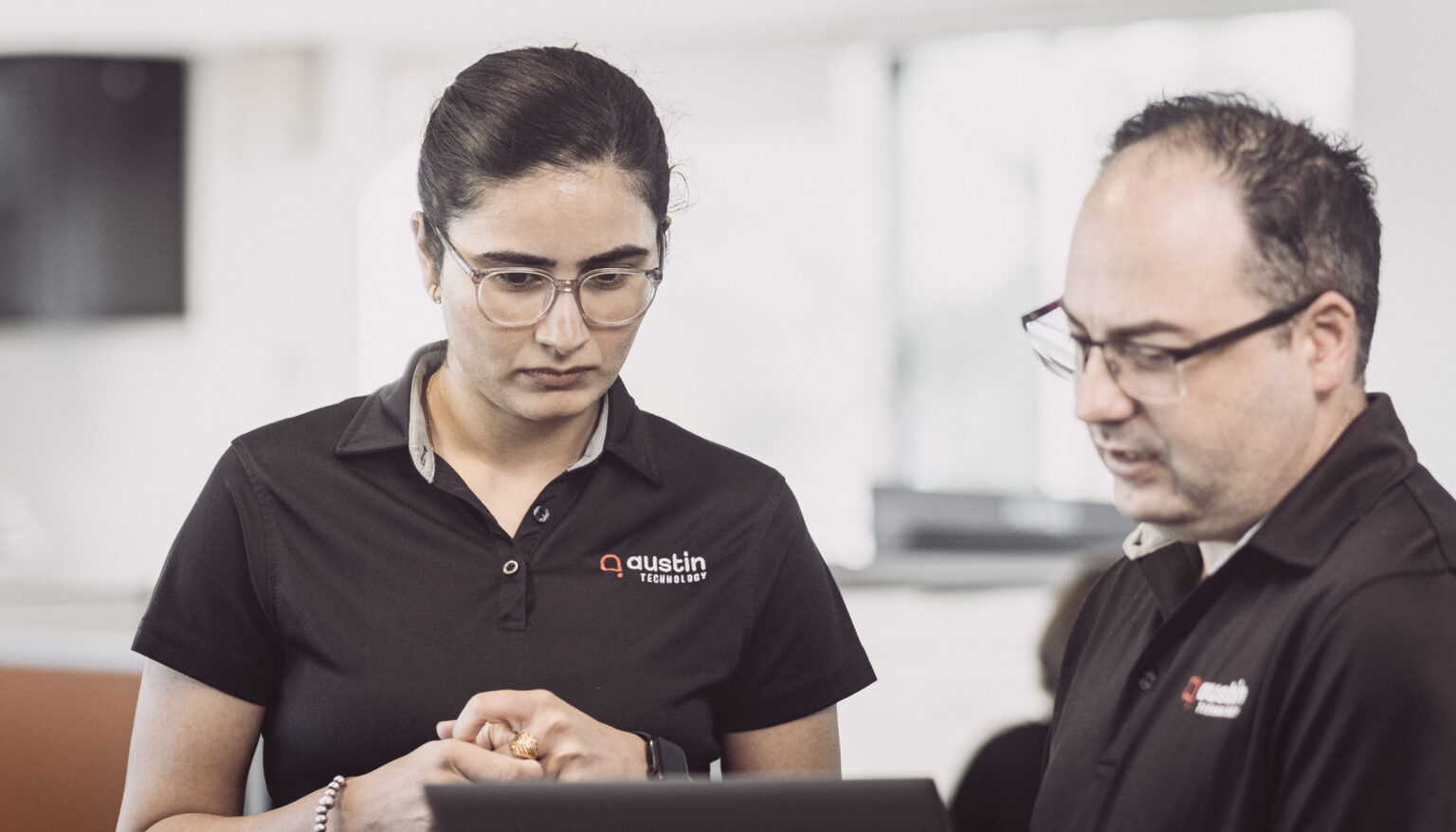 Two Austin Technology team members going through a client request