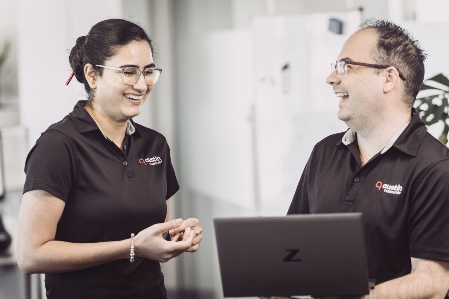 Two Austin Technology engineers talking through a client setup