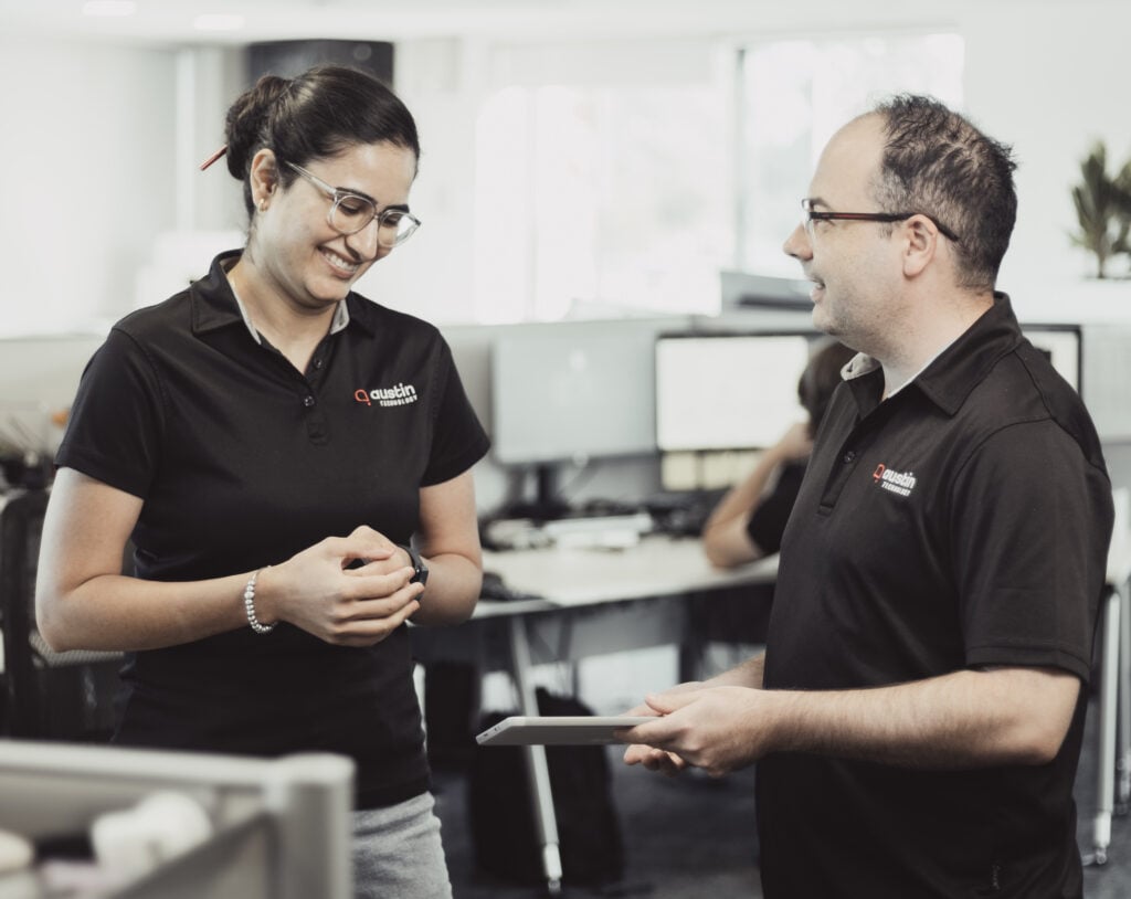 Two Austin Technology engineers talking through a client handover