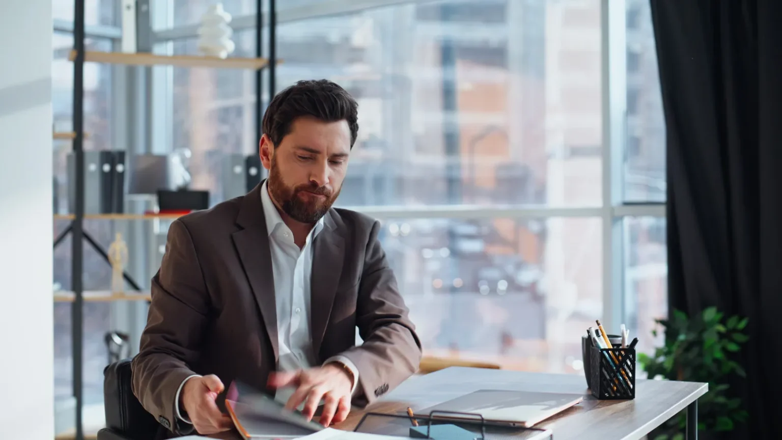A business owner reading a security report at his desk