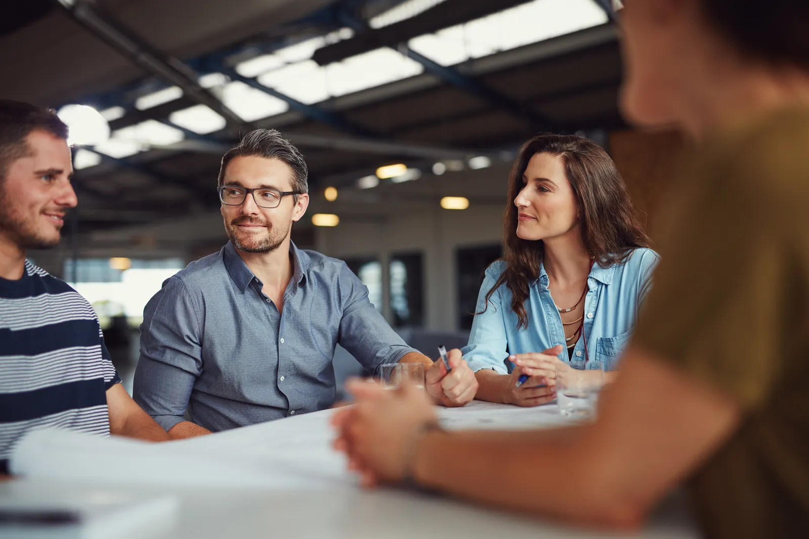 A small team in a relaxed meeting around a table