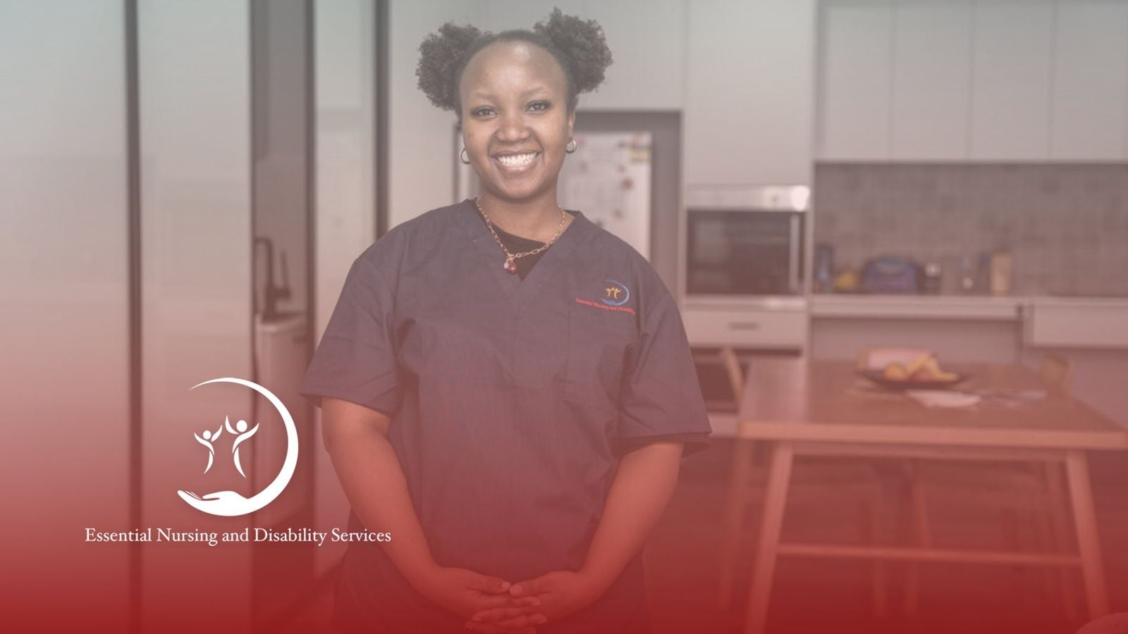 An Essential Nursing and Disability Services carer in branded scrubs in the kitchen of a care house