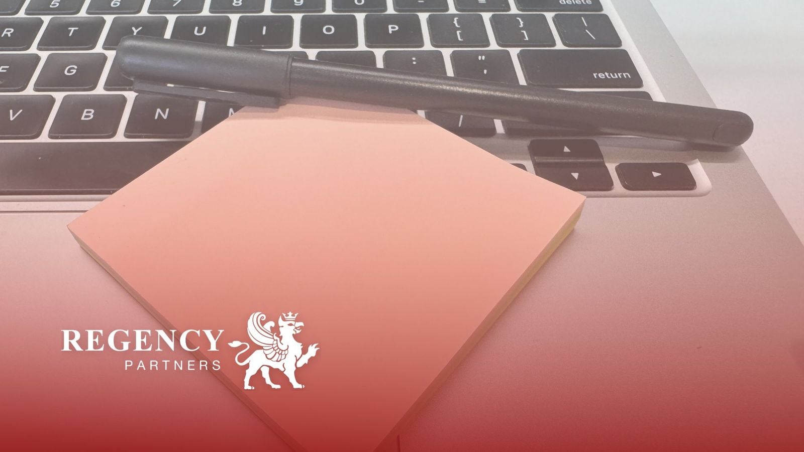 Regency Partners logo over a laptop keyboard with a pen and a sticky note